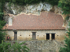 Domestic building built into the cliff side opposite Limeuil, France