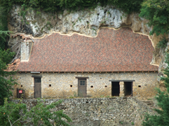 Domestic building built into the cliff side opposite Limeuil, France 